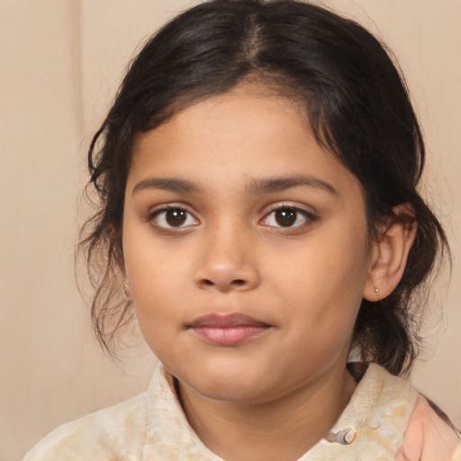 Joyful latino child female with medium  brown hair and brown eyes