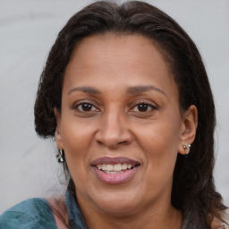 Joyful black adult female with medium  brown hair and brown eyes