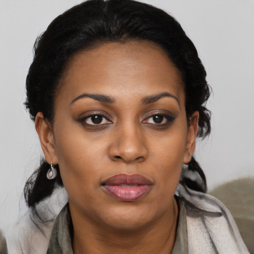 Joyful black young-adult female with medium  black hair and brown eyes