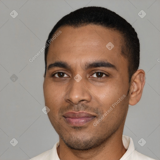 Joyful black young-adult male with short  black hair and brown eyes