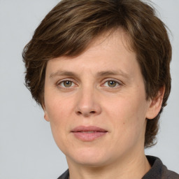 Joyful white adult female with medium  brown hair and grey eyes