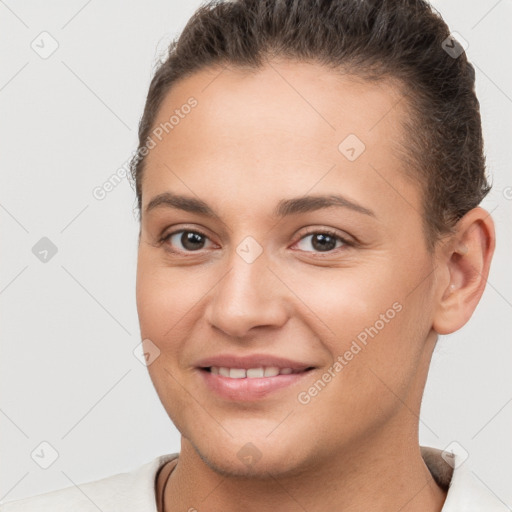 Joyful white young-adult female with short  brown hair and brown eyes