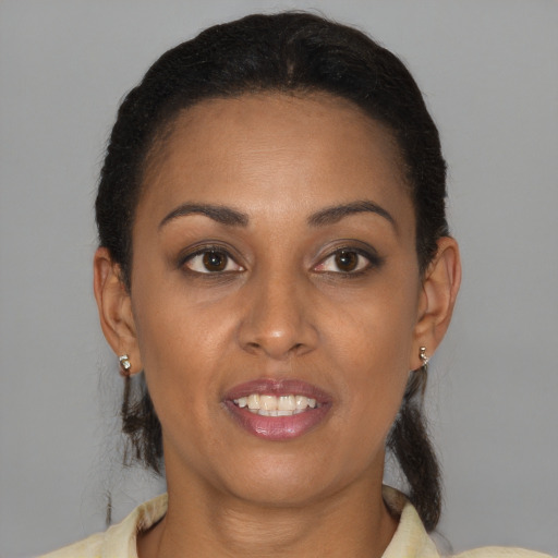 Joyful black young-adult female with medium  brown hair and brown eyes