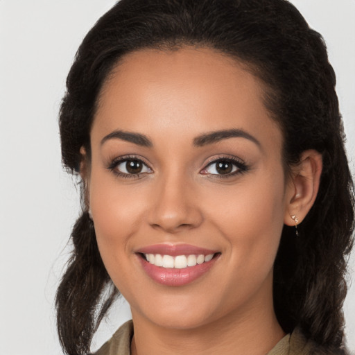 Joyful latino young-adult female with long  brown hair and brown eyes