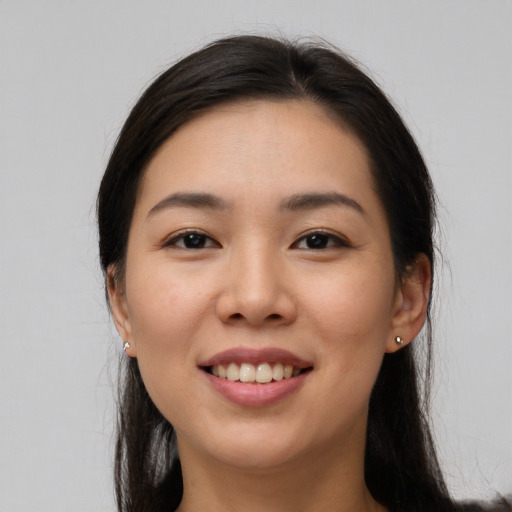 Joyful white young-adult female with long  black hair and brown eyes