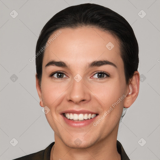 Joyful white young-adult female with short  black hair and brown eyes