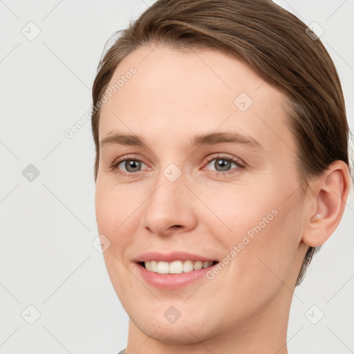 Joyful white young-adult female with short  brown hair and grey eyes