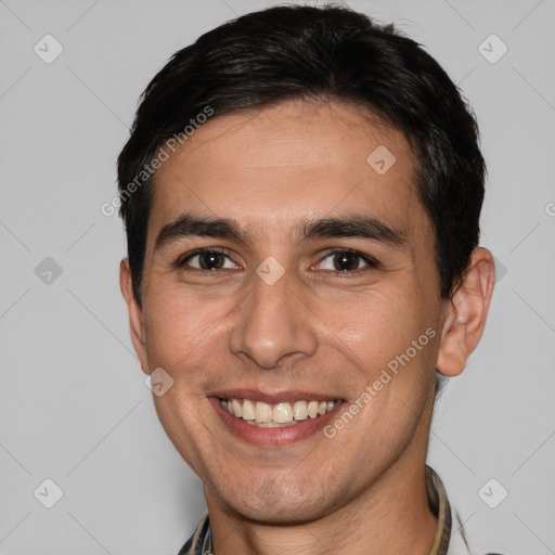 Joyful white young-adult male with short  black hair and brown eyes