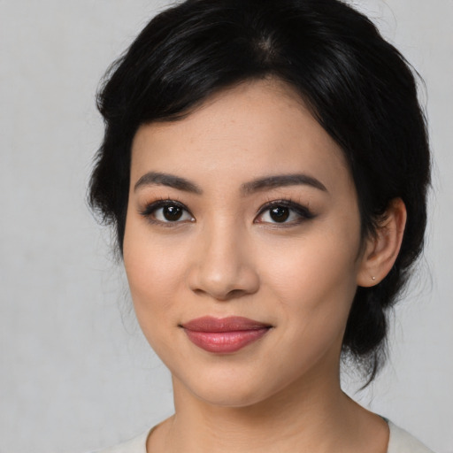 Joyful latino young-adult female with medium  black hair and brown eyes