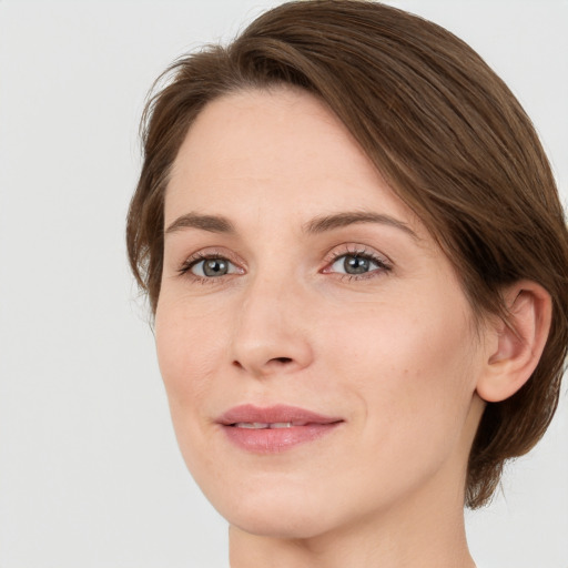 Joyful white young-adult female with medium  brown hair and green eyes