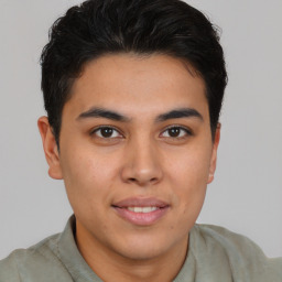 Joyful latino young-adult male with short  brown hair and brown eyes