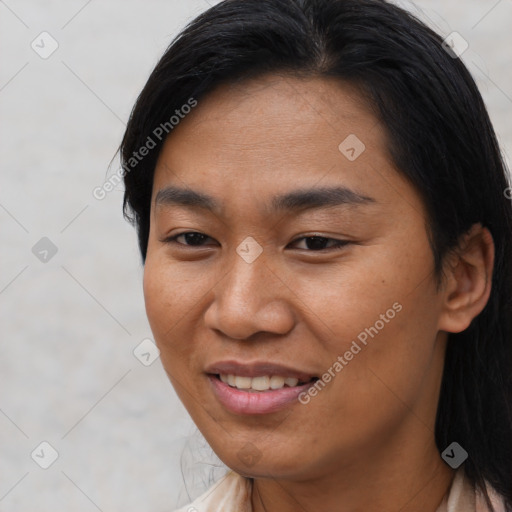 Joyful asian young-adult female with short  brown hair and brown eyes