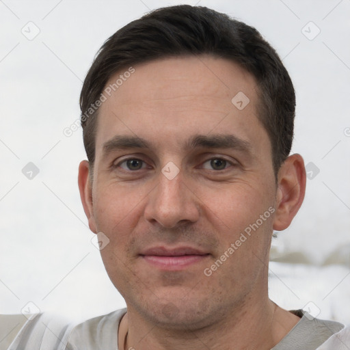 Joyful white adult male with short  black hair and brown eyes