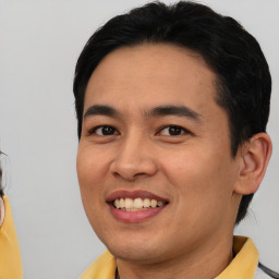 Joyful white young-adult male with short  black hair and brown eyes