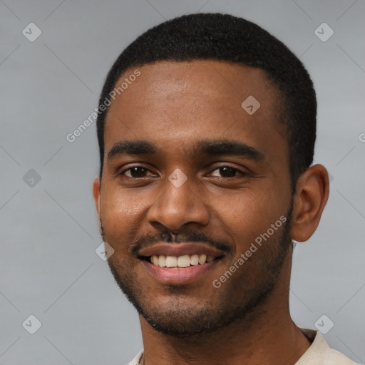 Joyful black young-adult male with short  black hair and brown eyes