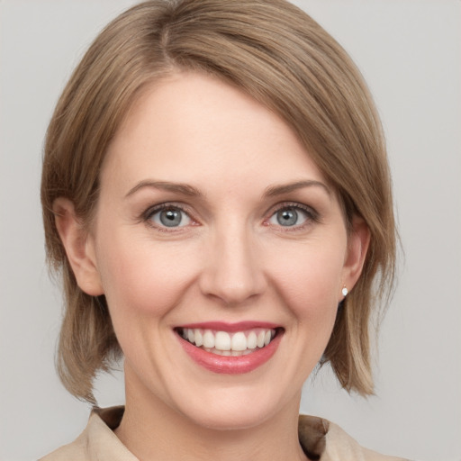 Joyful white young-adult female with medium  brown hair and blue eyes