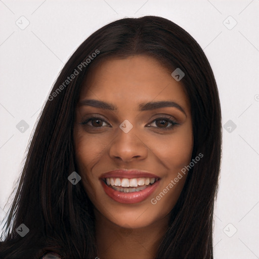 Joyful black young-adult female with long  brown hair and brown eyes