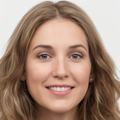 Joyful white young-adult female with long  brown hair and green eyes