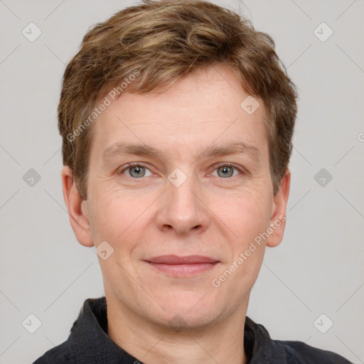 Joyful white adult male with short  brown hair and grey eyes