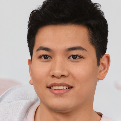 Joyful asian young-adult male with short  black hair and brown eyes