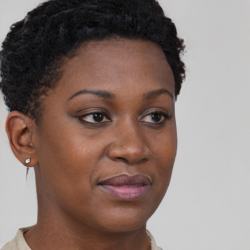Joyful black young-adult female with short  brown hair and brown eyes