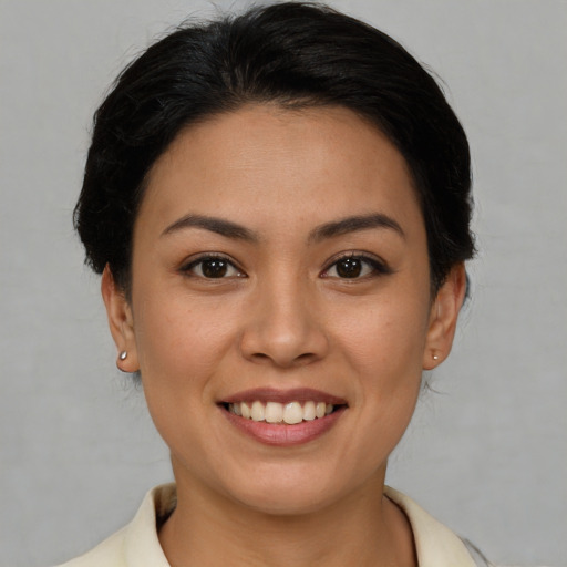 Joyful asian young-adult female with medium  brown hair and brown eyes