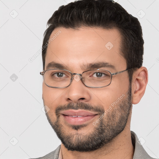 Joyful white young-adult male with short  black hair and brown eyes