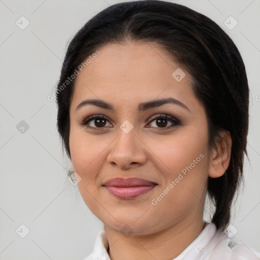 Joyful latino young-adult female with medium  brown hair and brown eyes