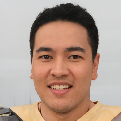 Joyful asian young-adult male with short  black hair and brown eyes