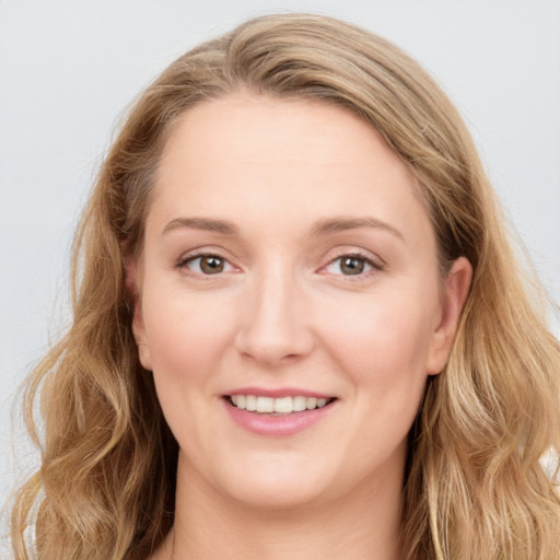 Joyful white young-adult female with long  brown hair and blue eyes