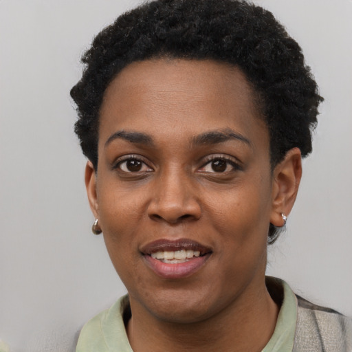 Joyful black young-adult female with short  black hair and brown eyes