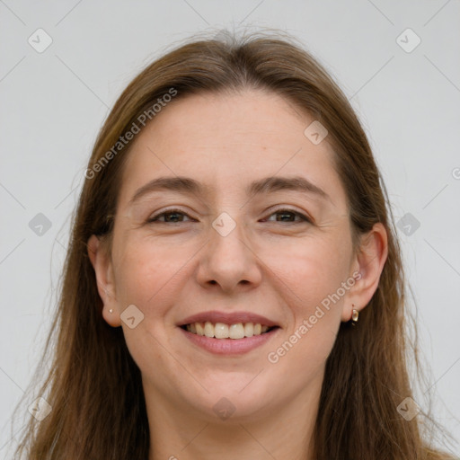 Joyful white adult female with long  brown hair and grey eyes