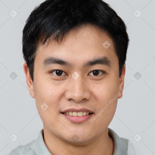 Joyful asian young-adult male with short  black hair and brown eyes