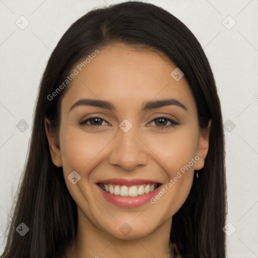 Joyful latino young-adult female with long  brown hair and brown eyes