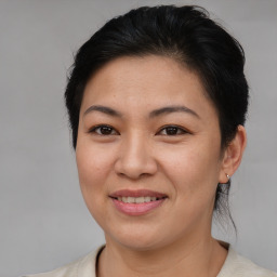 Joyful asian young-adult female with medium  brown hair and brown eyes