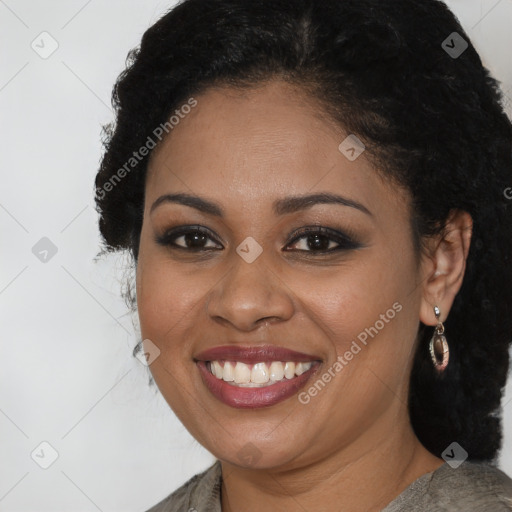 Joyful black young-adult female with long  brown hair and brown eyes