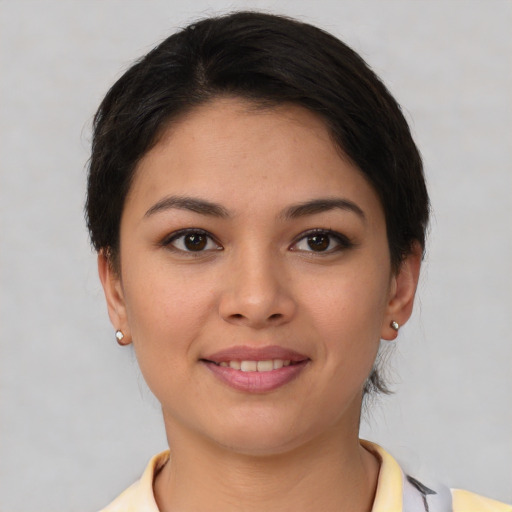 Joyful latino young-adult female with short  brown hair and brown eyes