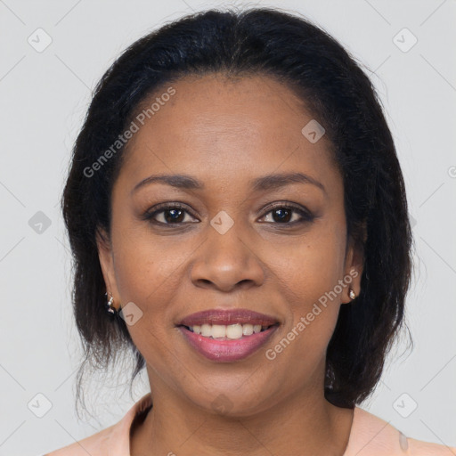 Joyful black adult female with medium  brown hair and brown eyes