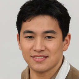 Joyful asian young-adult male with short  brown hair and brown eyes