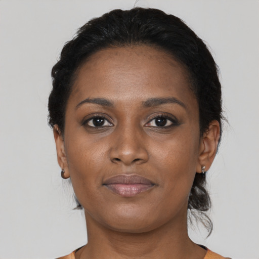 Joyful black young-adult female with medium  brown hair and brown eyes