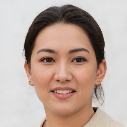 Joyful asian young-adult female with medium  brown hair and brown eyes