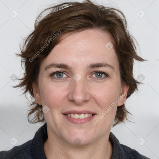 Joyful white adult female with medium  brown hair and blue eyes