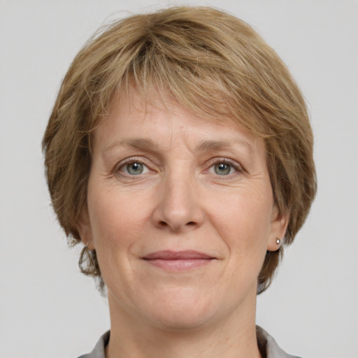 Joyful white adult female with medium  brown hair and grey eyes