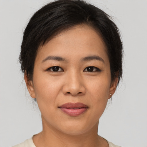 Joyful asian young-adult female with short  brown hair and brown eyes