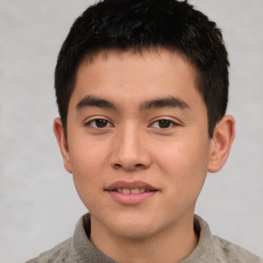 Joyful asian young-adult male with short  brown hair and brown eyes