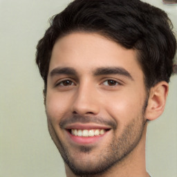 Joyful white young-adult male with short  black hair and brown eyes