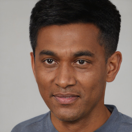 Joyful latino adult male with short  black hair and brown eyes