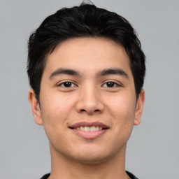 Joyful asian young-adult male with short  black hair and brown eyes