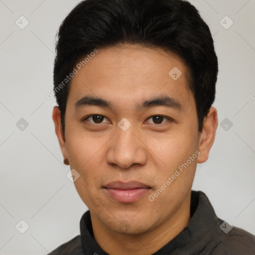 Joyful asian young-adult male with short  black hair and brown eyes