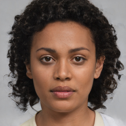 Neutral black young-adult female with medium  brown hair and brown eyes